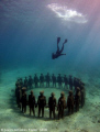   Divemaster Gary free dives down vicissitudes statue installation. Sculptures Jason deCaires Taylor installation  